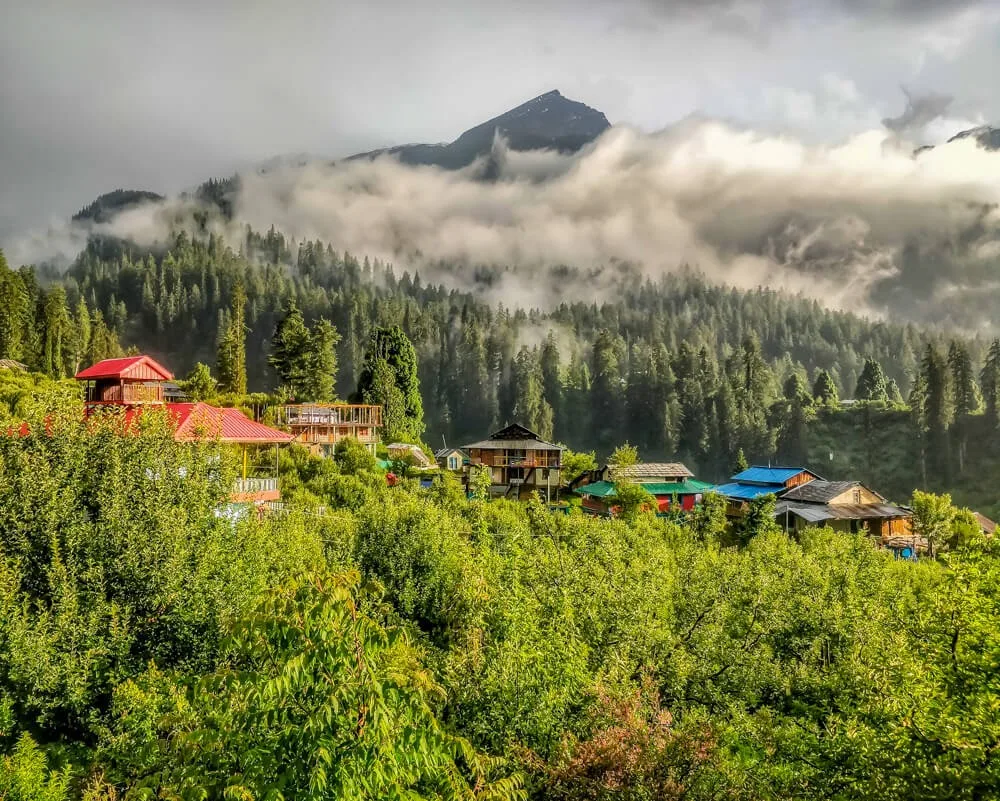 Sunlight and clouds above green Kalga village